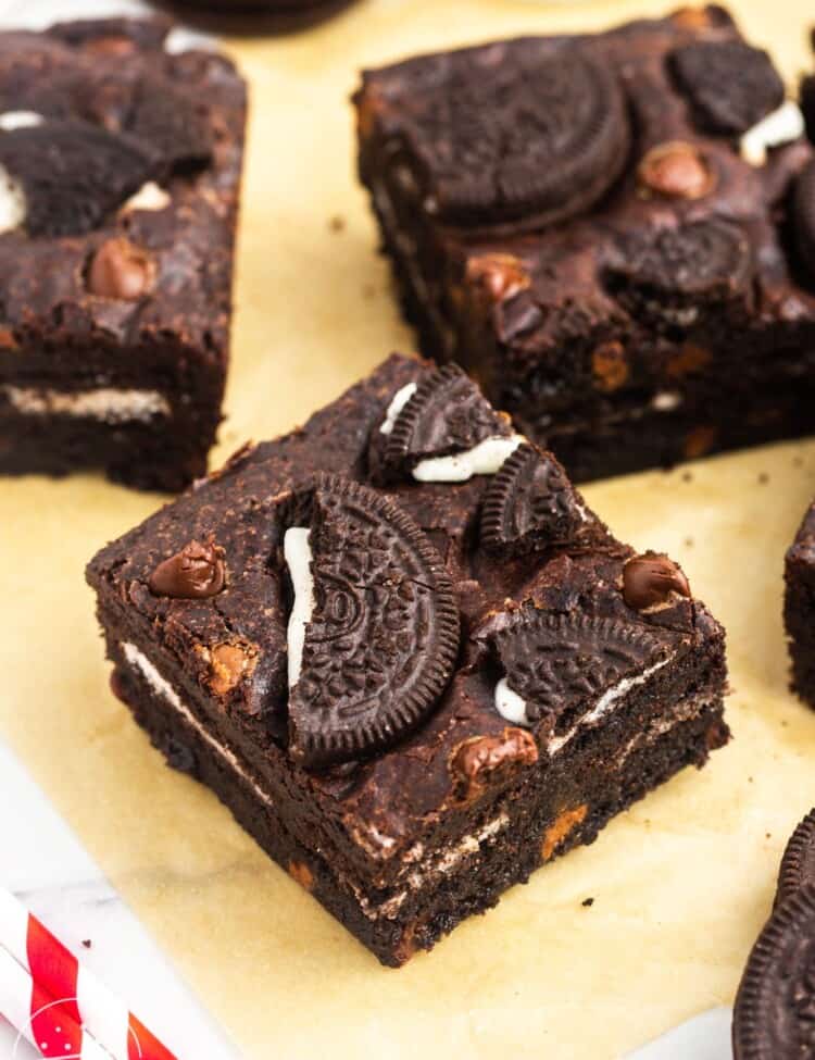 Squares of Oreo brownies placed on parchment paper