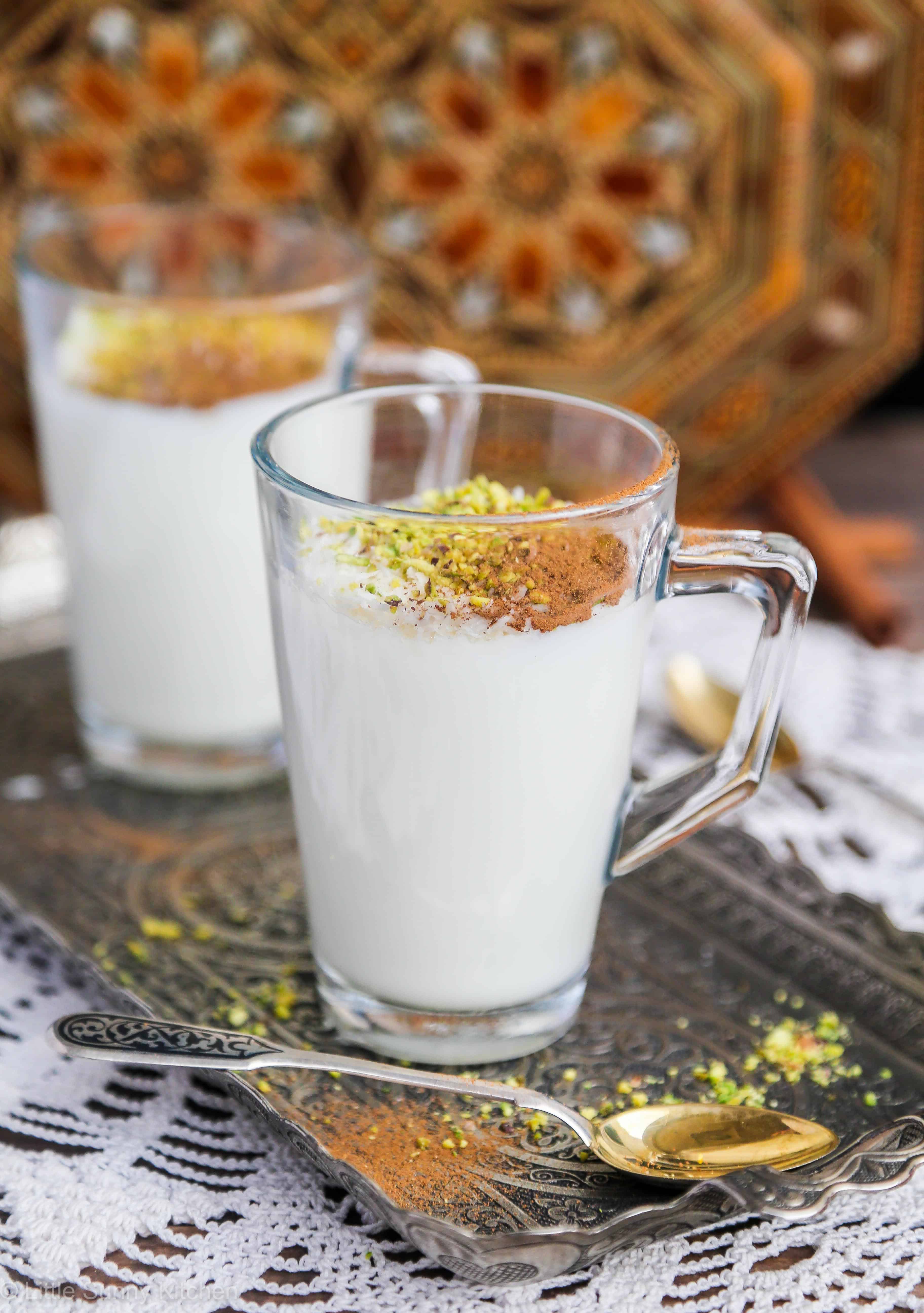 2 glass mugs with sahlab, and a small teaspoon