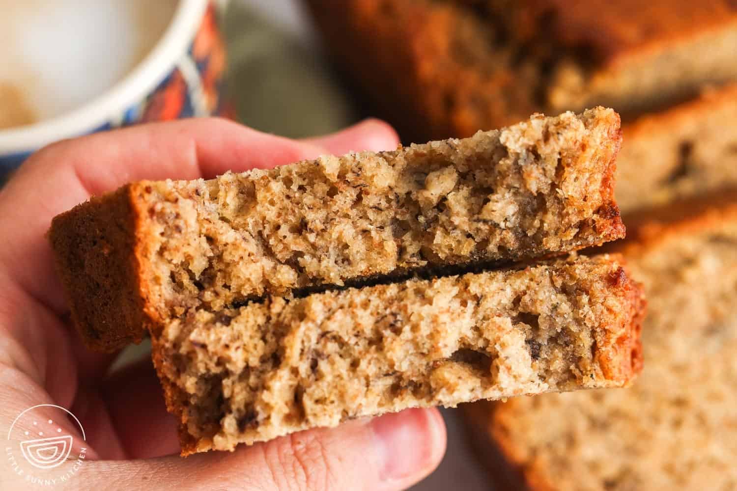 Holding 2 pieces of banana bread to show the texture