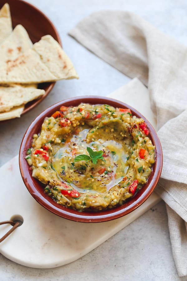 Baba ganoush aubergine/eggplant dip in a traditional plate, on a marble tray