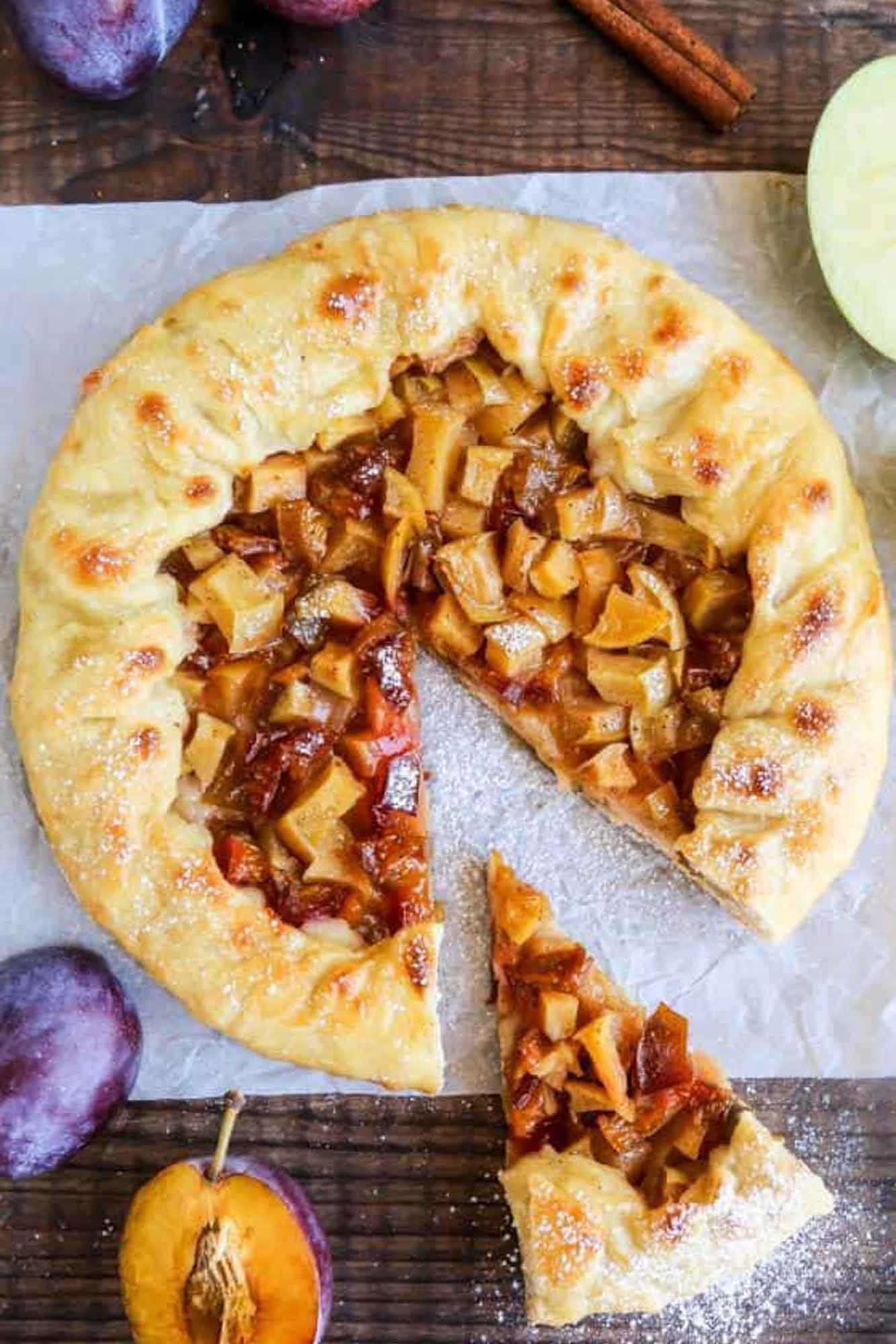 Overhead shot of apple plum galette placed on parchment paper