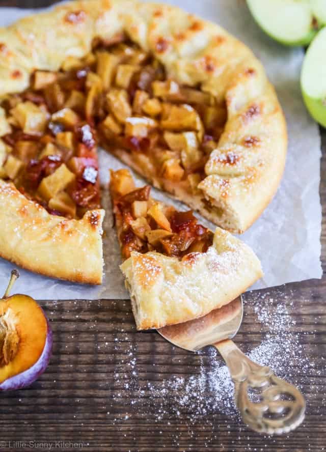 Serving a plum apple galette slice.