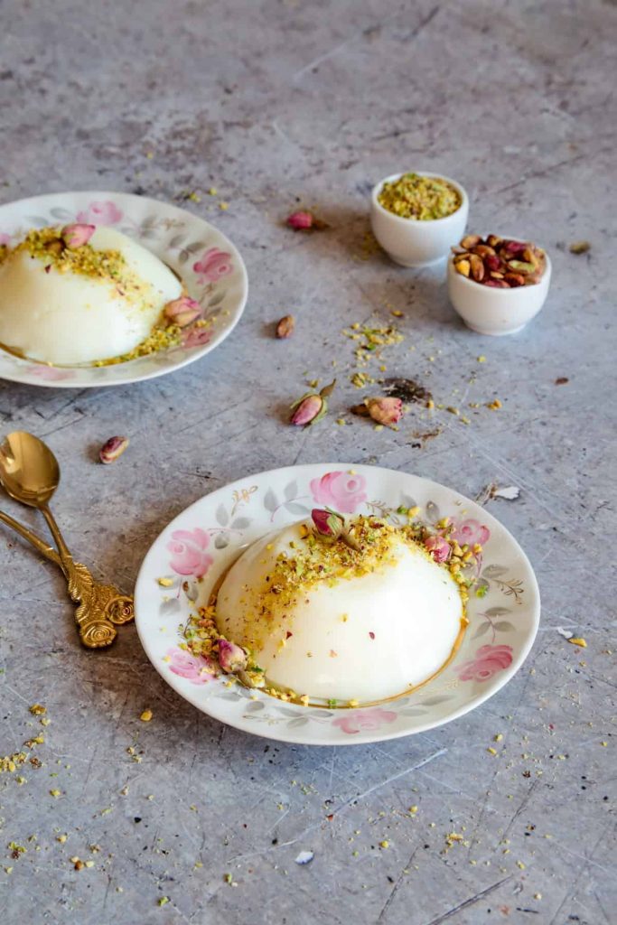An incredible and creamy Middle Eastern milk pudding infused with rose water, and topped with crushed pistachios. 