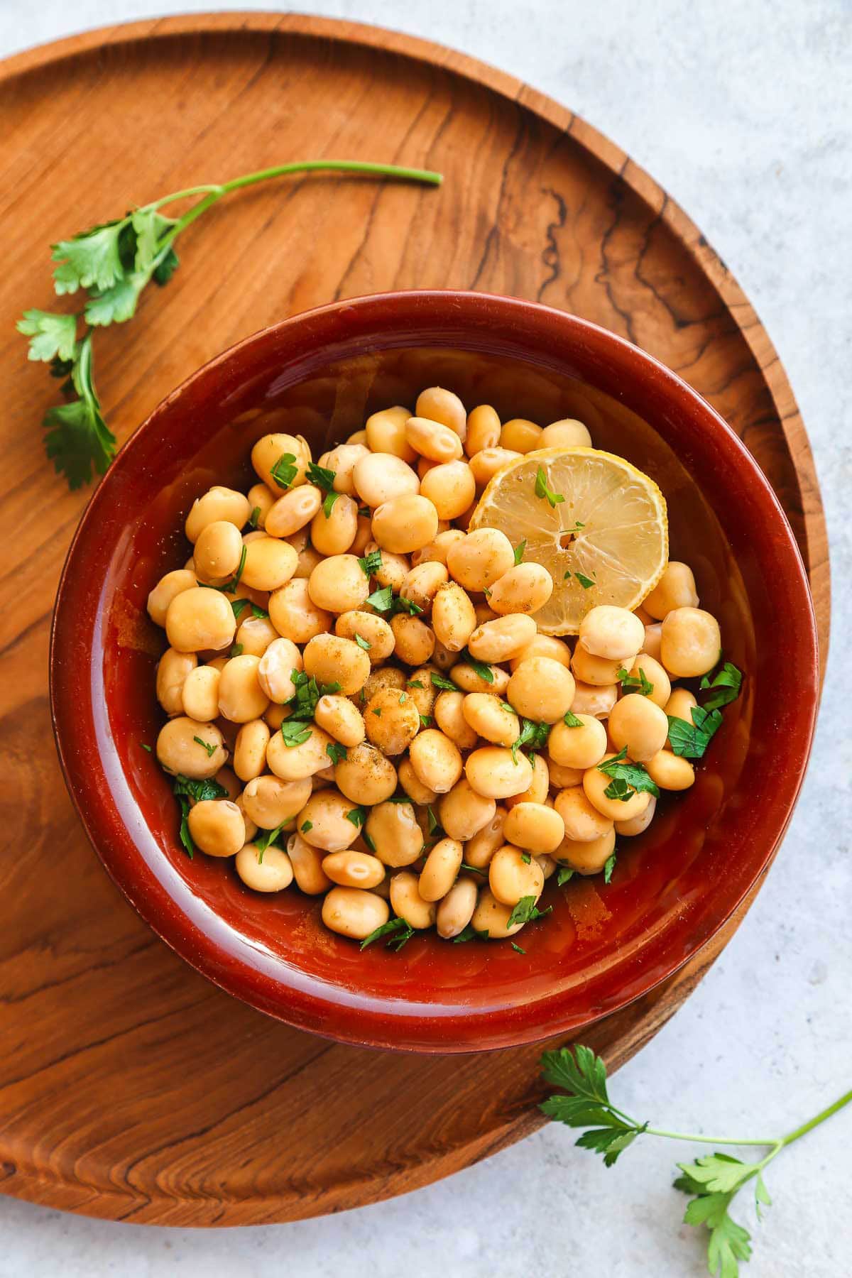 Cooked Lupini beans served with parsley in a traditional middle eastern bowl