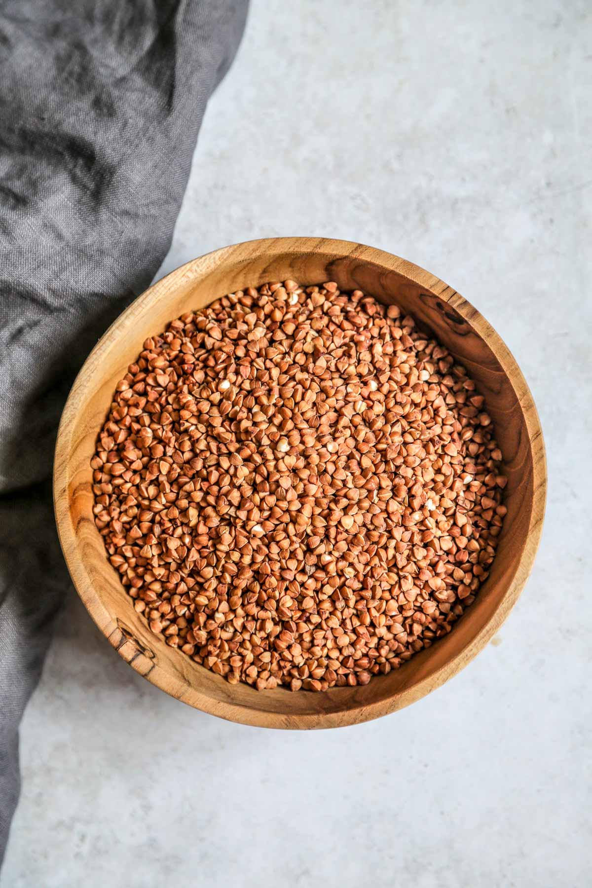 uncooked buckwheat groats in a wooden bowl