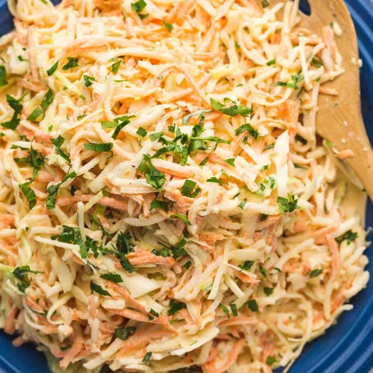 Overhead shot of daikon radish slaw served in a navy platter