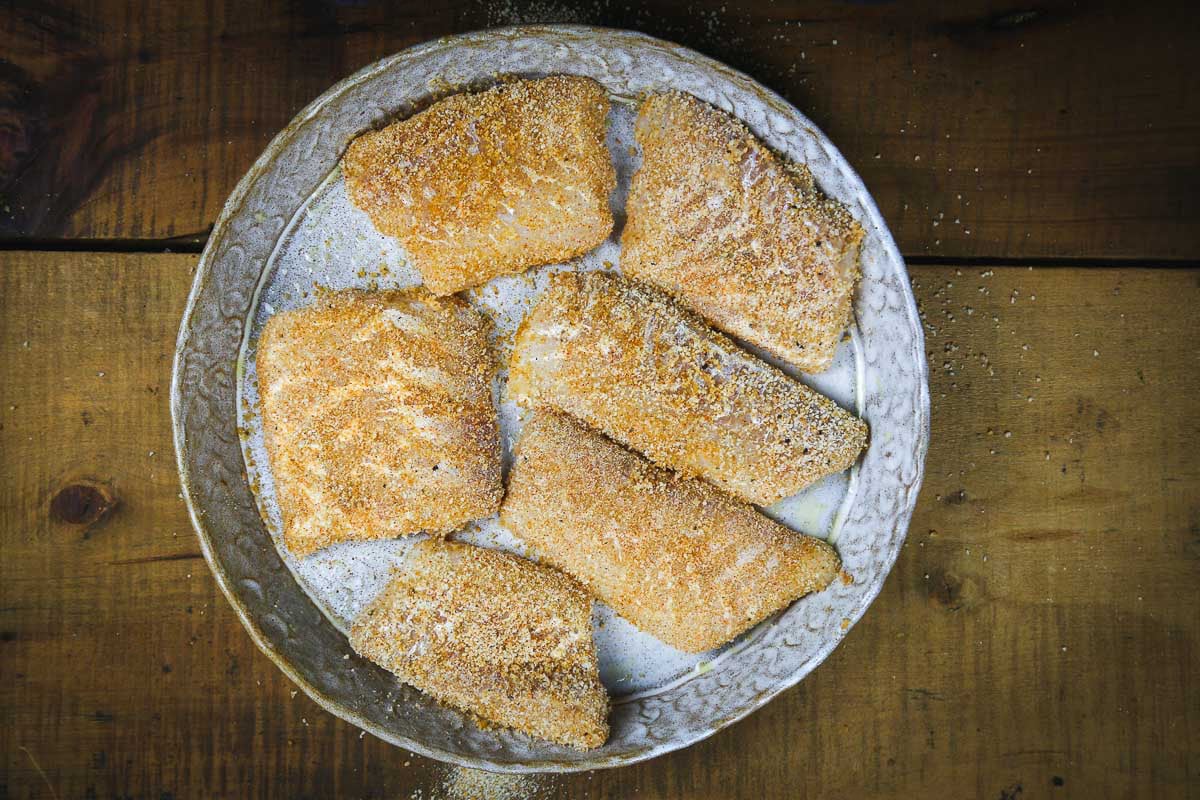 Breaded raw fish fillets in a bowl