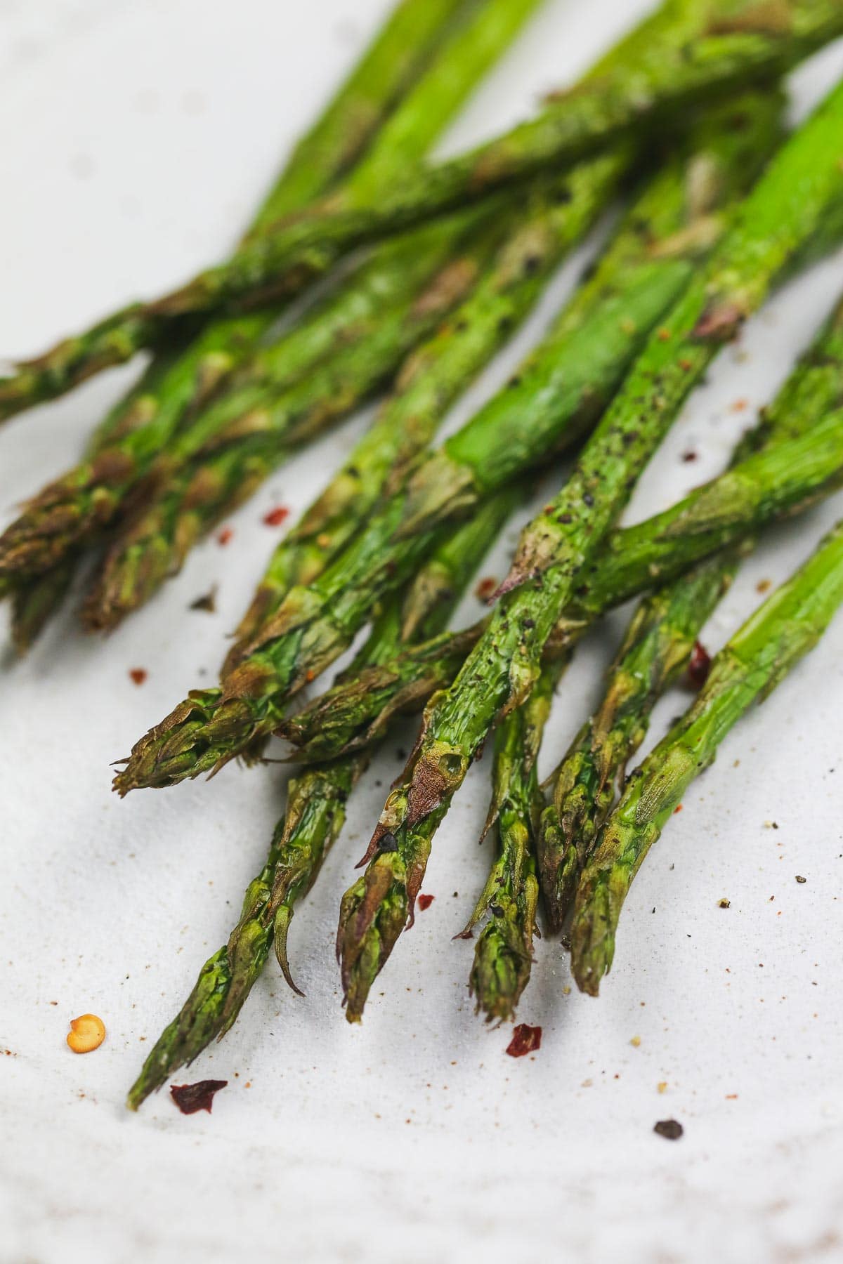 A close up shot of crispy asparagus with chilli flakes.  