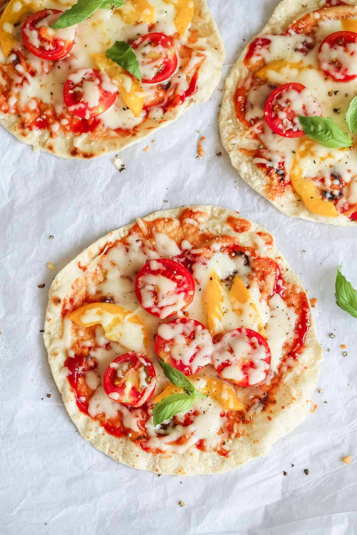 Easy 5-minute flatbread pizzas ready, laid on parchment paper