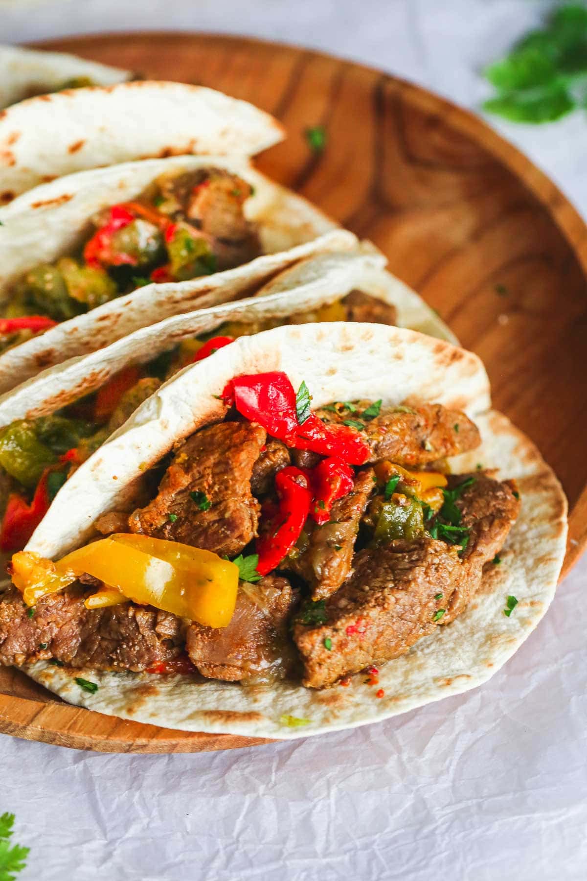 A close up shot of Instant Pot Steak Fajitas in tortillas