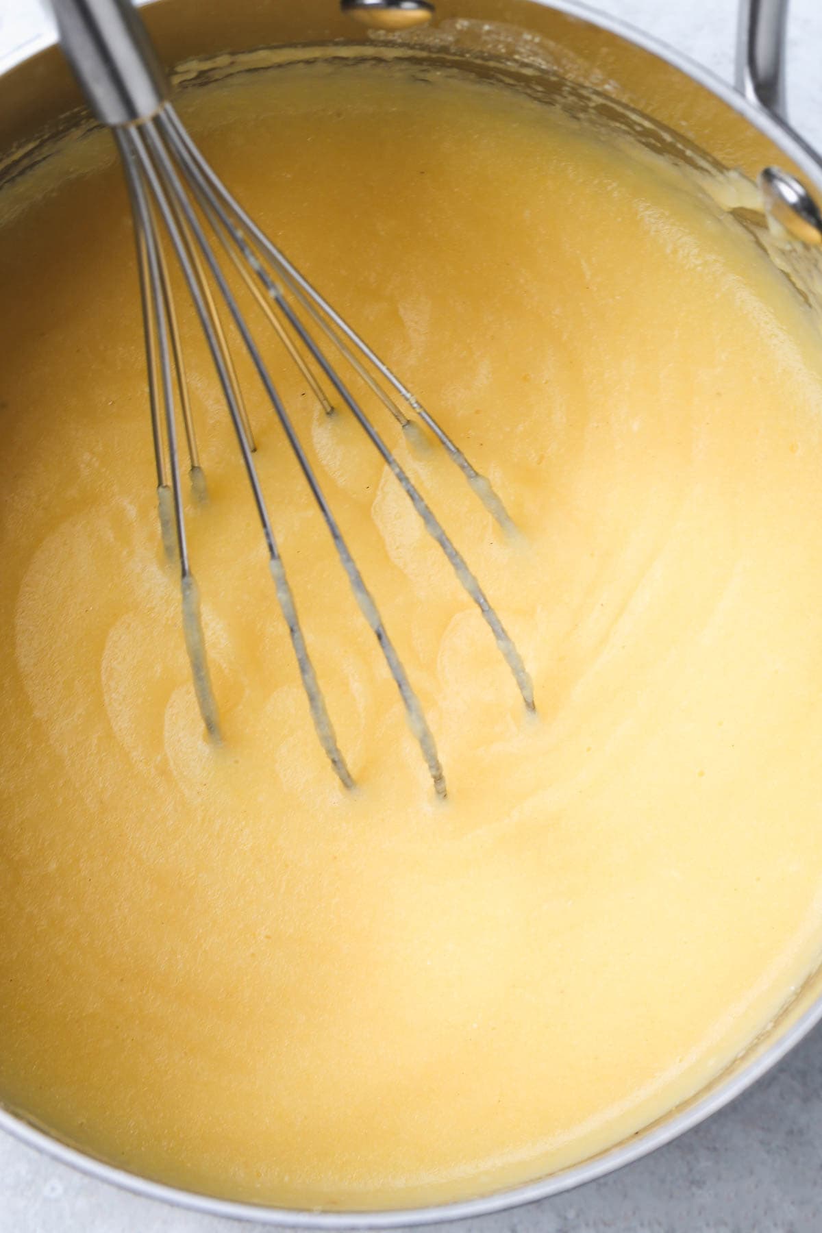 Cooking polenta porridge with a whisk