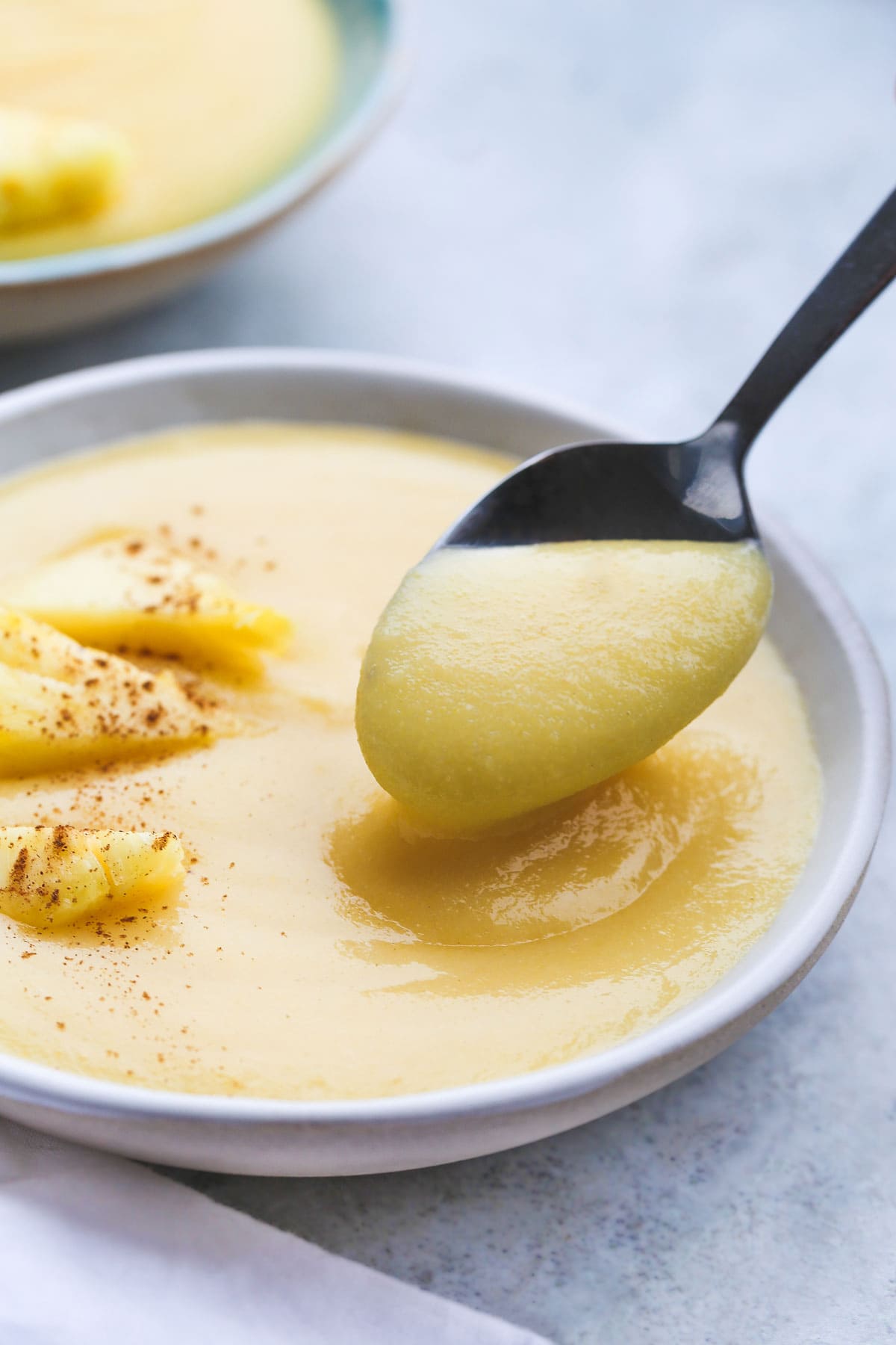 Cornmeal porridge in a bowl with a spoonful of porridge