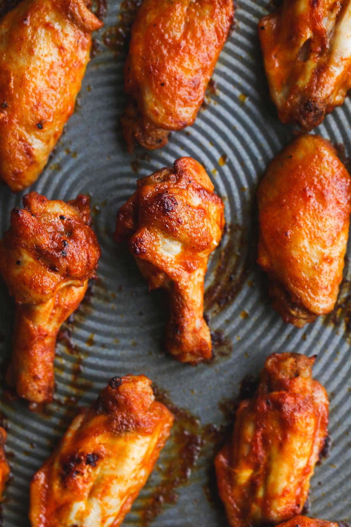 A close up of Crispy and perfectly cooked chicken wings on a sheet pan