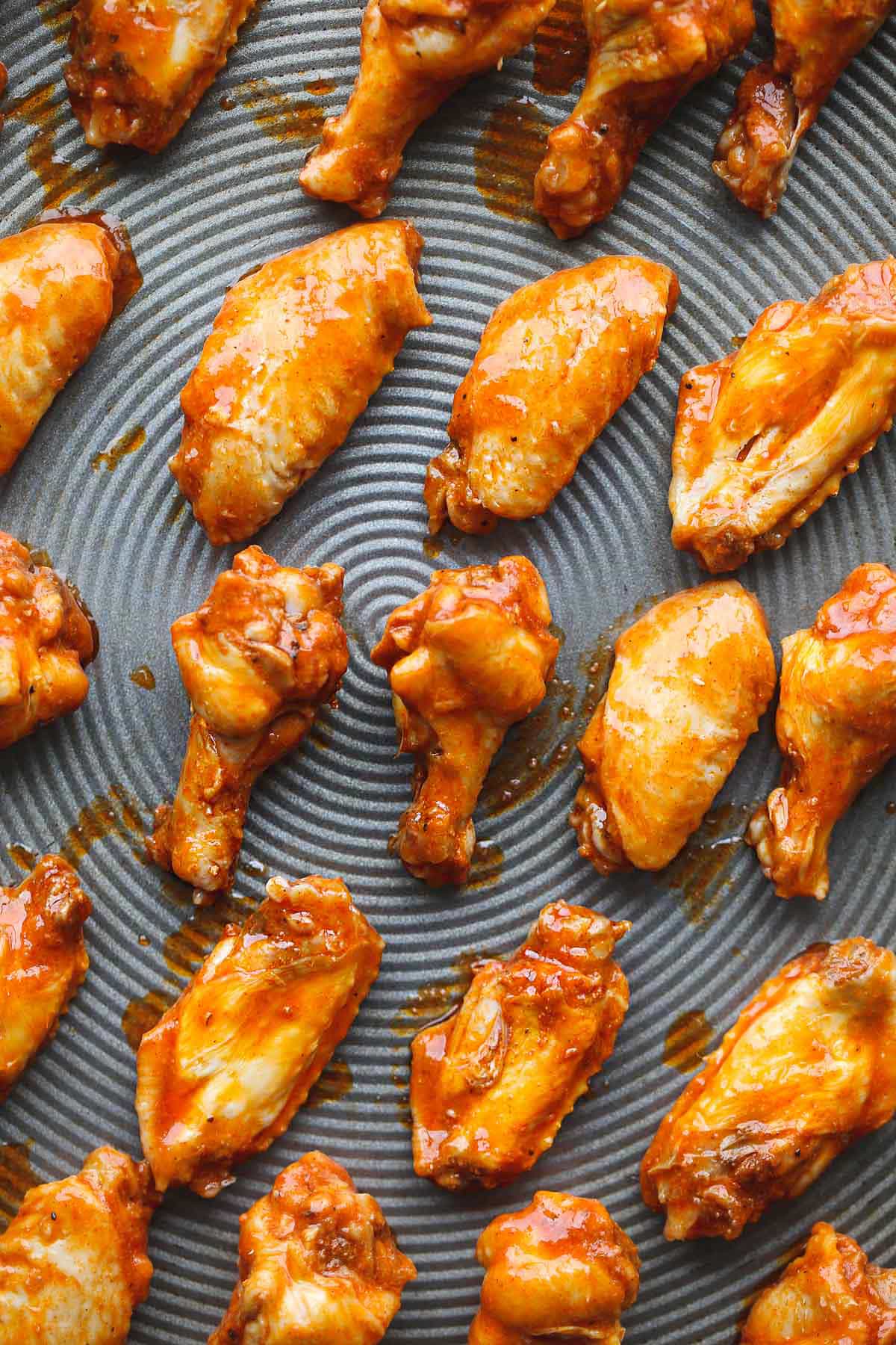 Chicken wings on a sheet pan before broiling