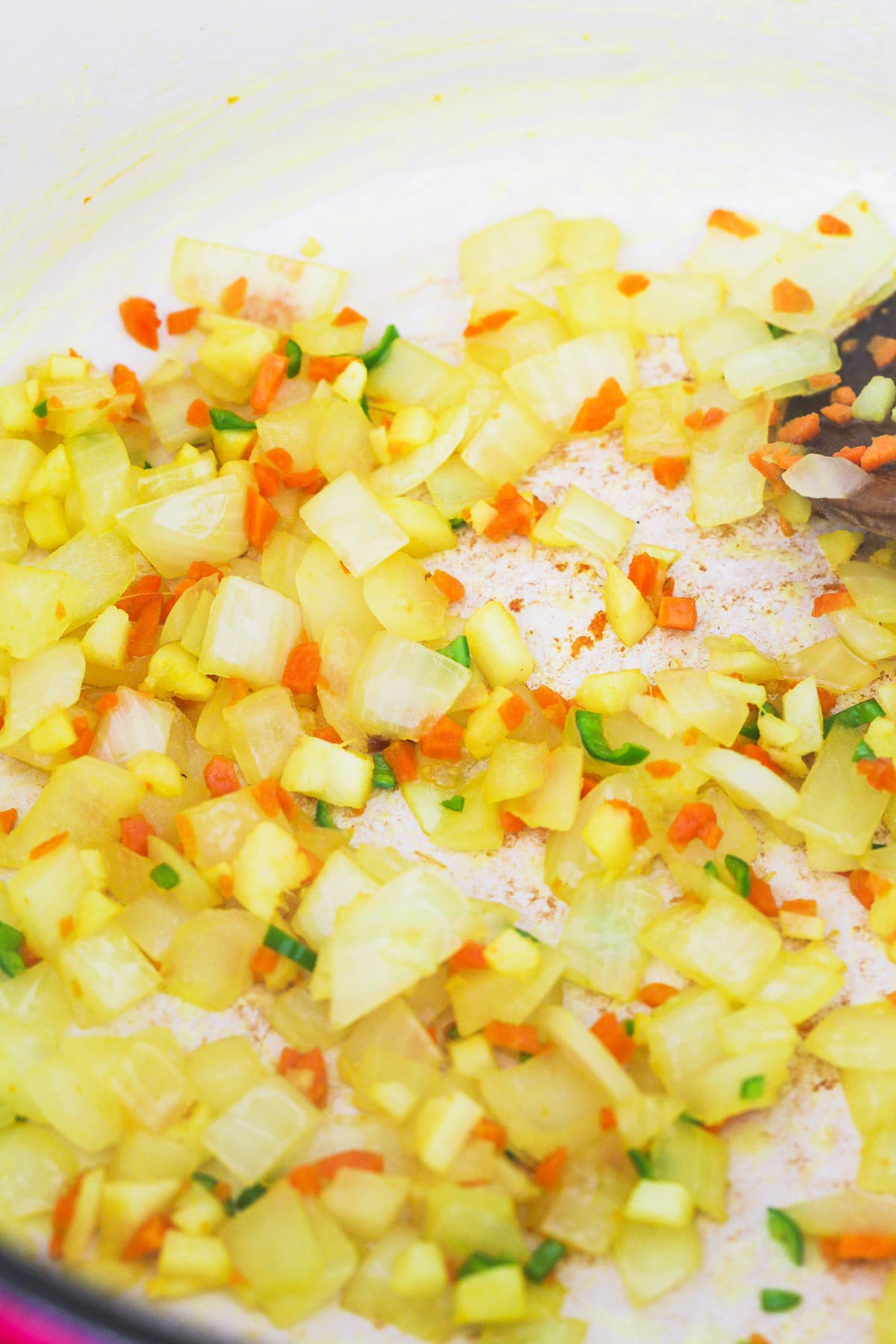 Sauteing diced onion, with garlic, green chili and fresh turmeric