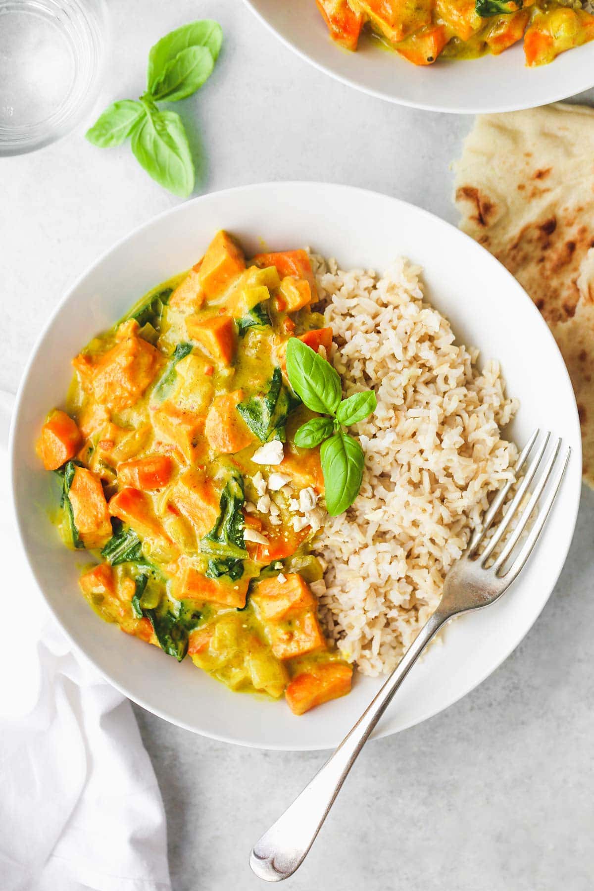 Sweet Potato Curry in a white bowl served with brown rice