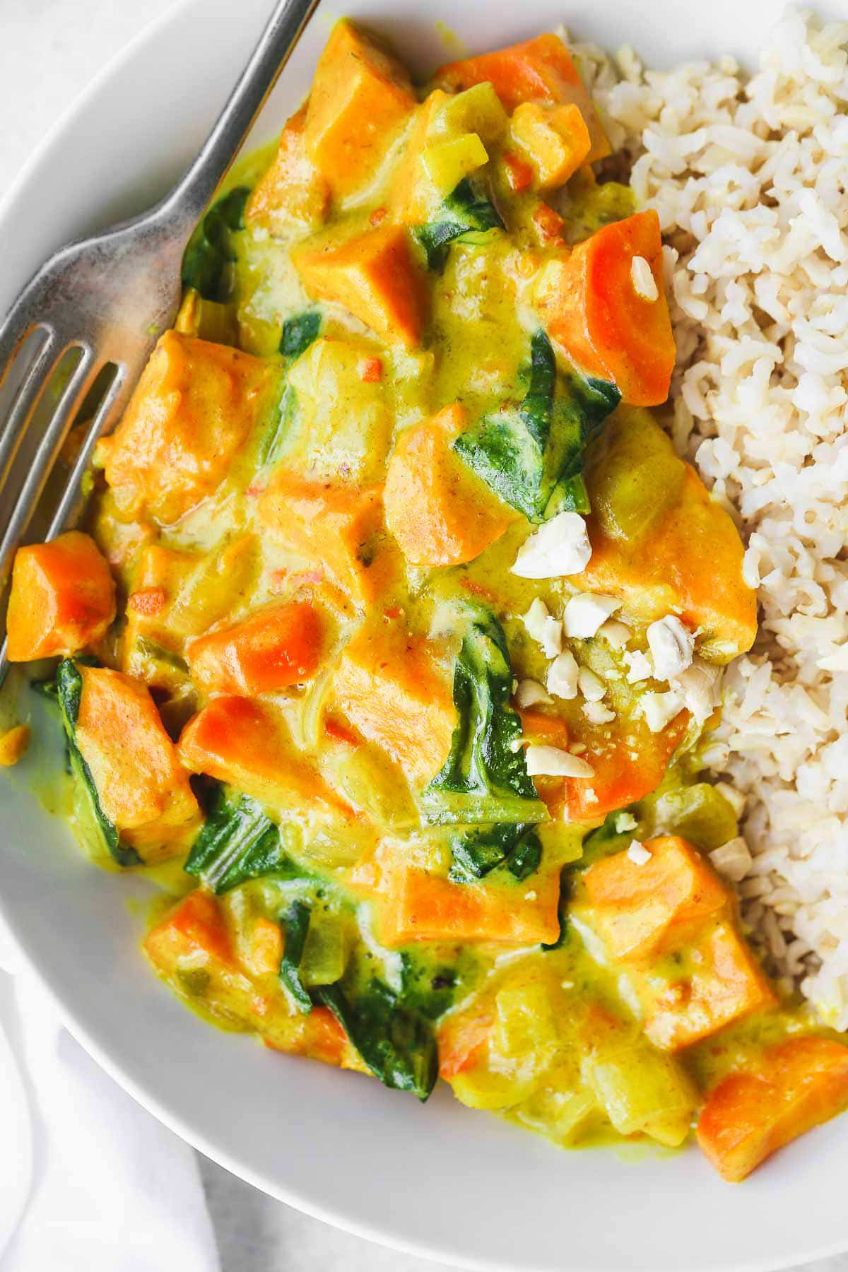 A close up image of Sweet Potato Curry served with brown rice