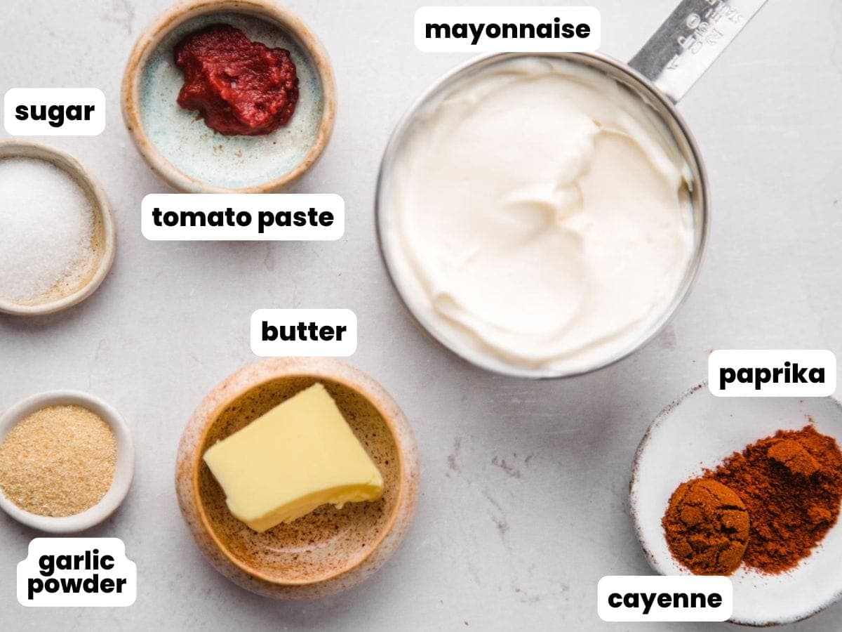 Ingredients needed to make yum yum sauce including mayo, tomato paste, butter, sugar, garlic powder, paprika, and cayenne.