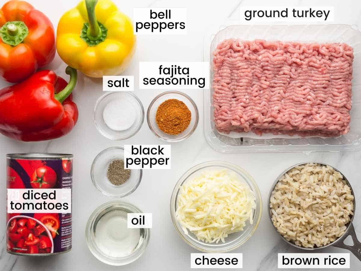 Ingredients needed to make mexican stuffed peppers including ground meat, peppers, rice, cheese, diced tomatoes, and seasonings.