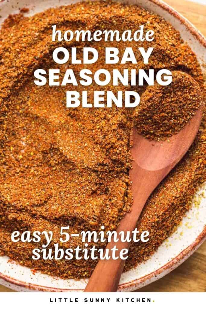 Homemade Old Bay seasoning blend in a bowl with a wooden spoon.