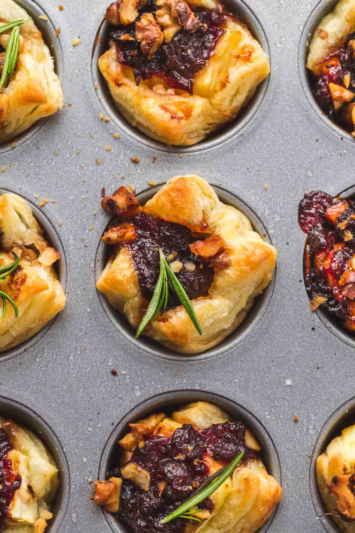 Overhead shot of baked brie bites in a muffin pan