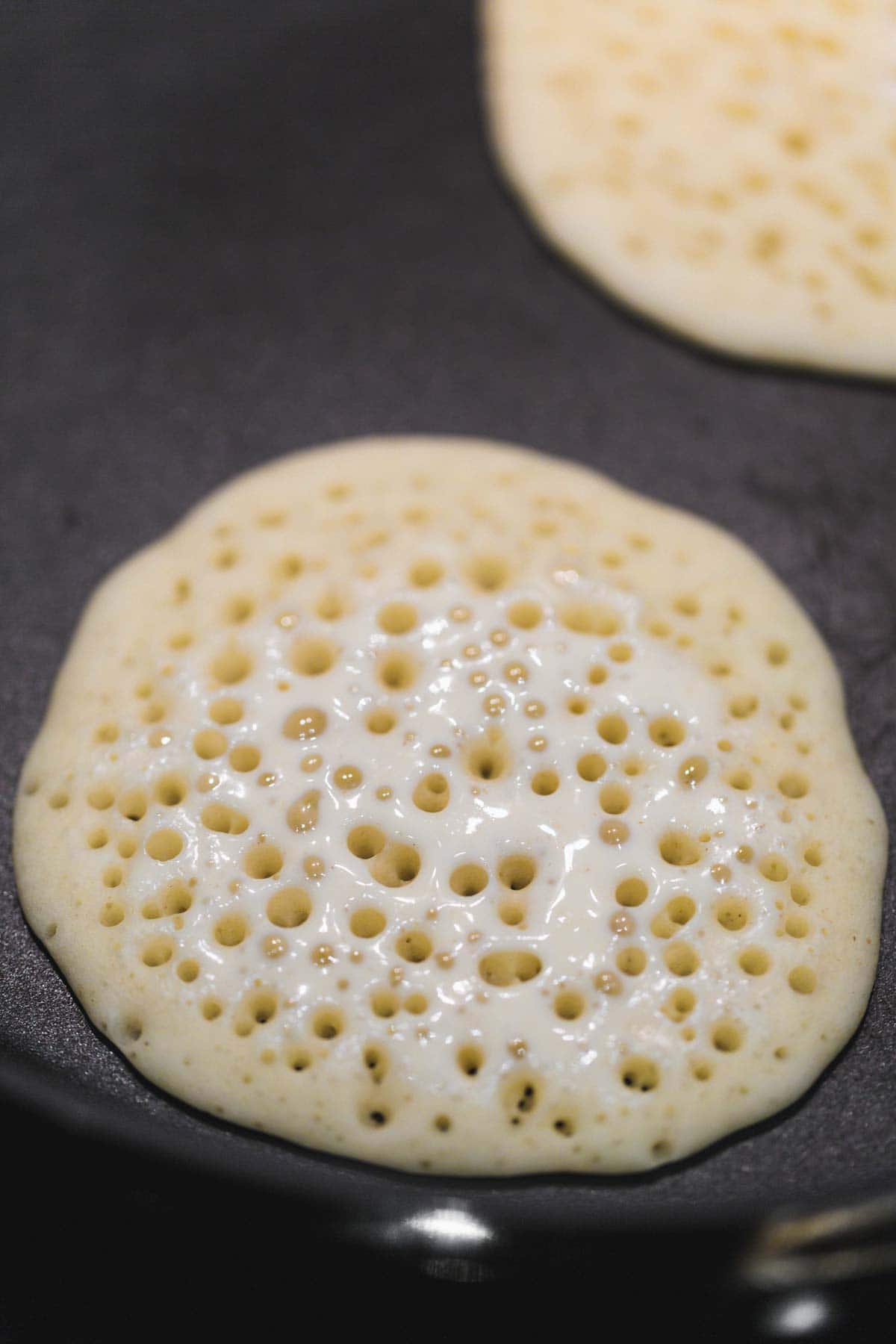Frying the atayef pancakes on a dry pan