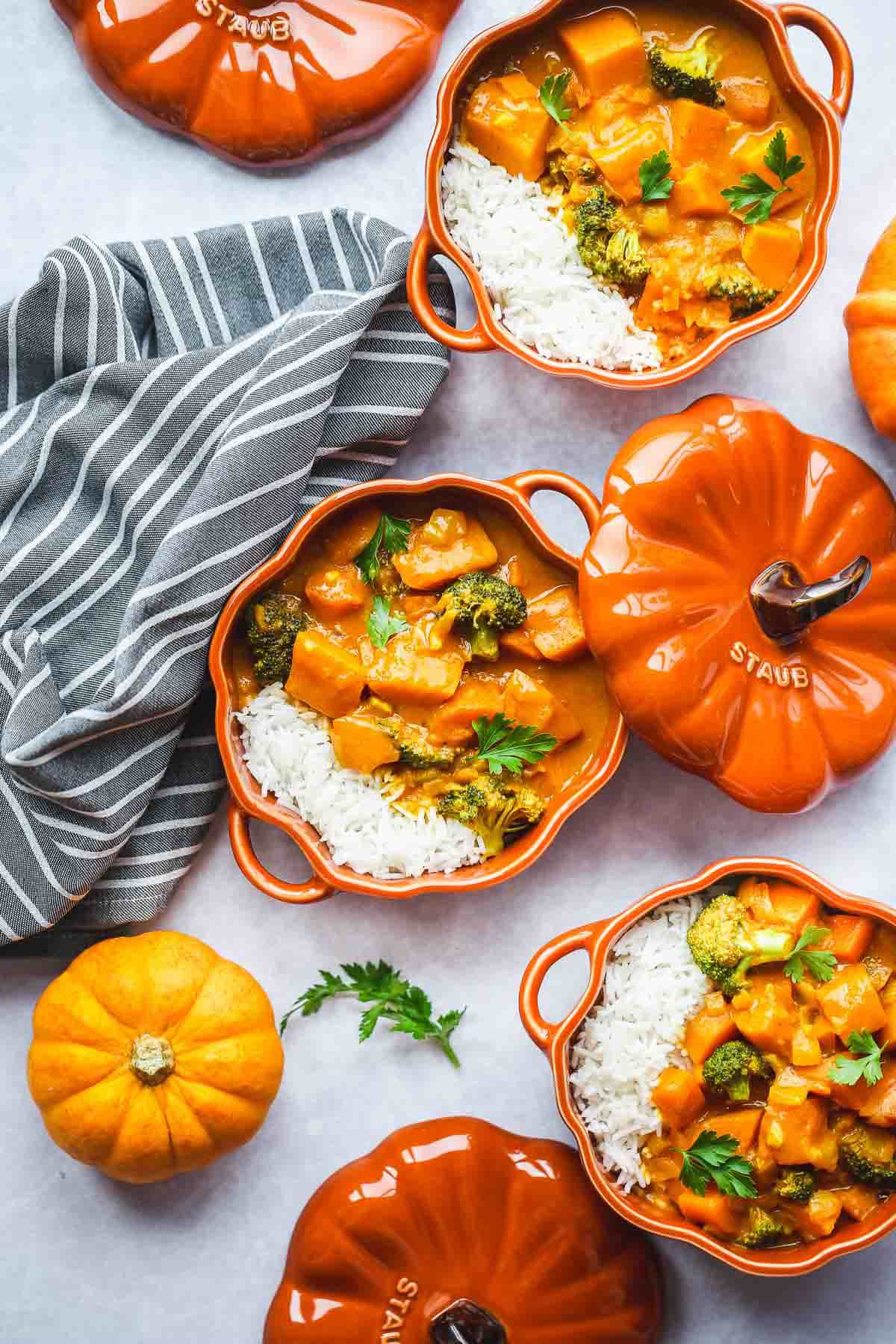 Pumpkin curry served in small pumpkin shaped Staub cocottes