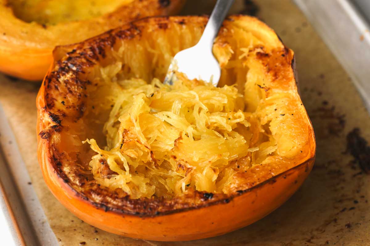 Perfectly roasted and fluffed spaghetti squash with a fork