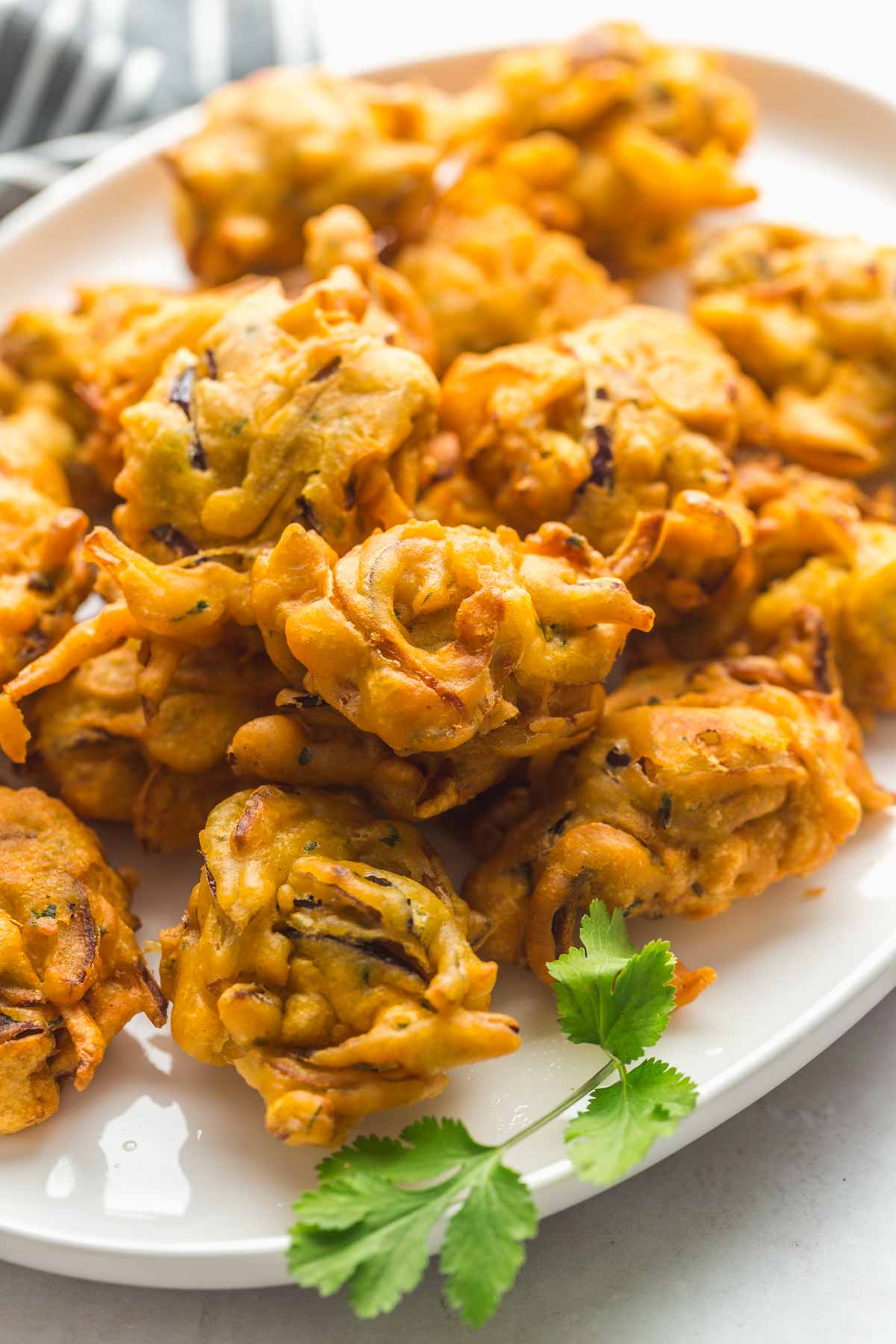 Fried onion bhaji served on a white platter