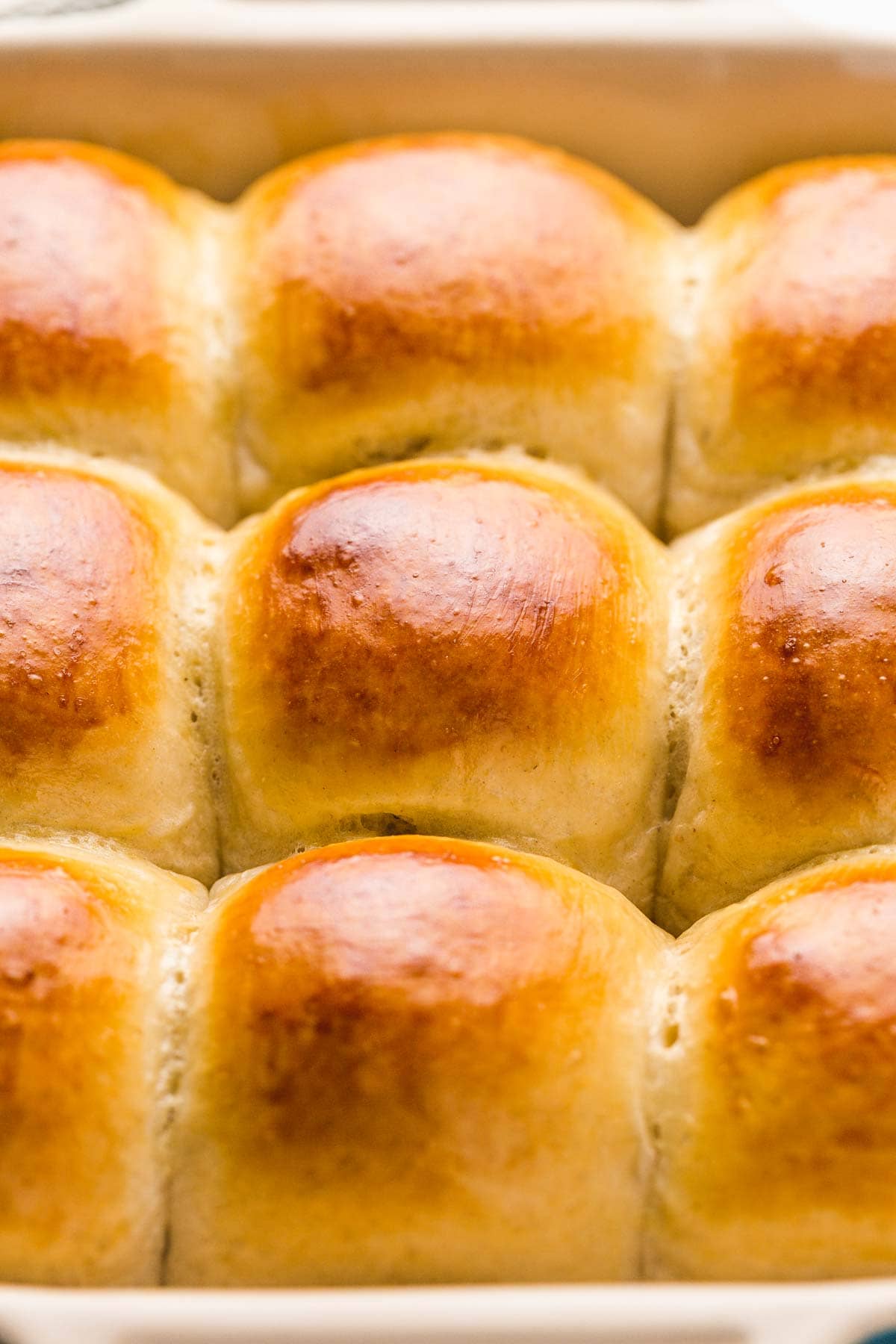 Overhead shot of golden dinner rolls in a pan