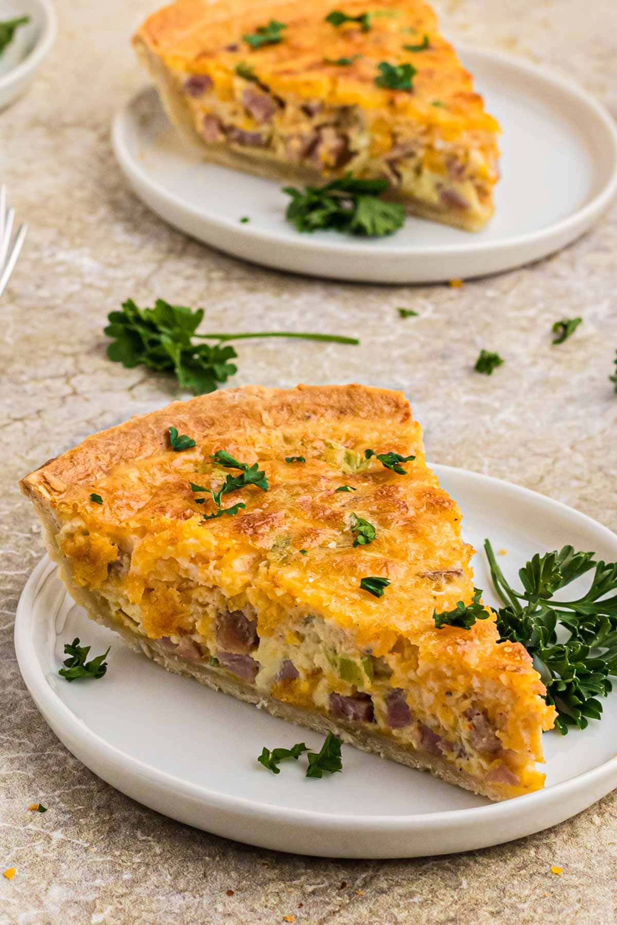 A slice of quiche on a small plate
