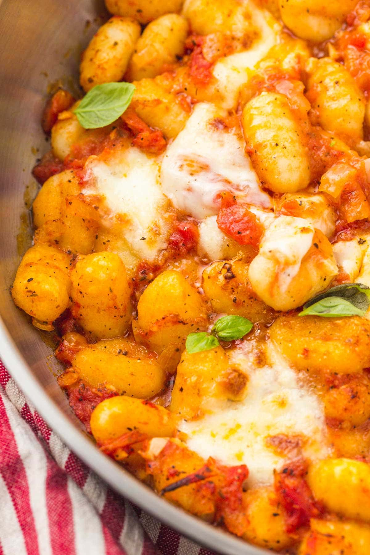 Close up shot of crispy gnocchi in the pan, with bubbly crispy cheese
