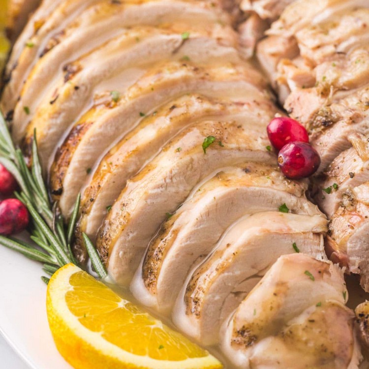 Sliced turkey breast on a platter with gravy