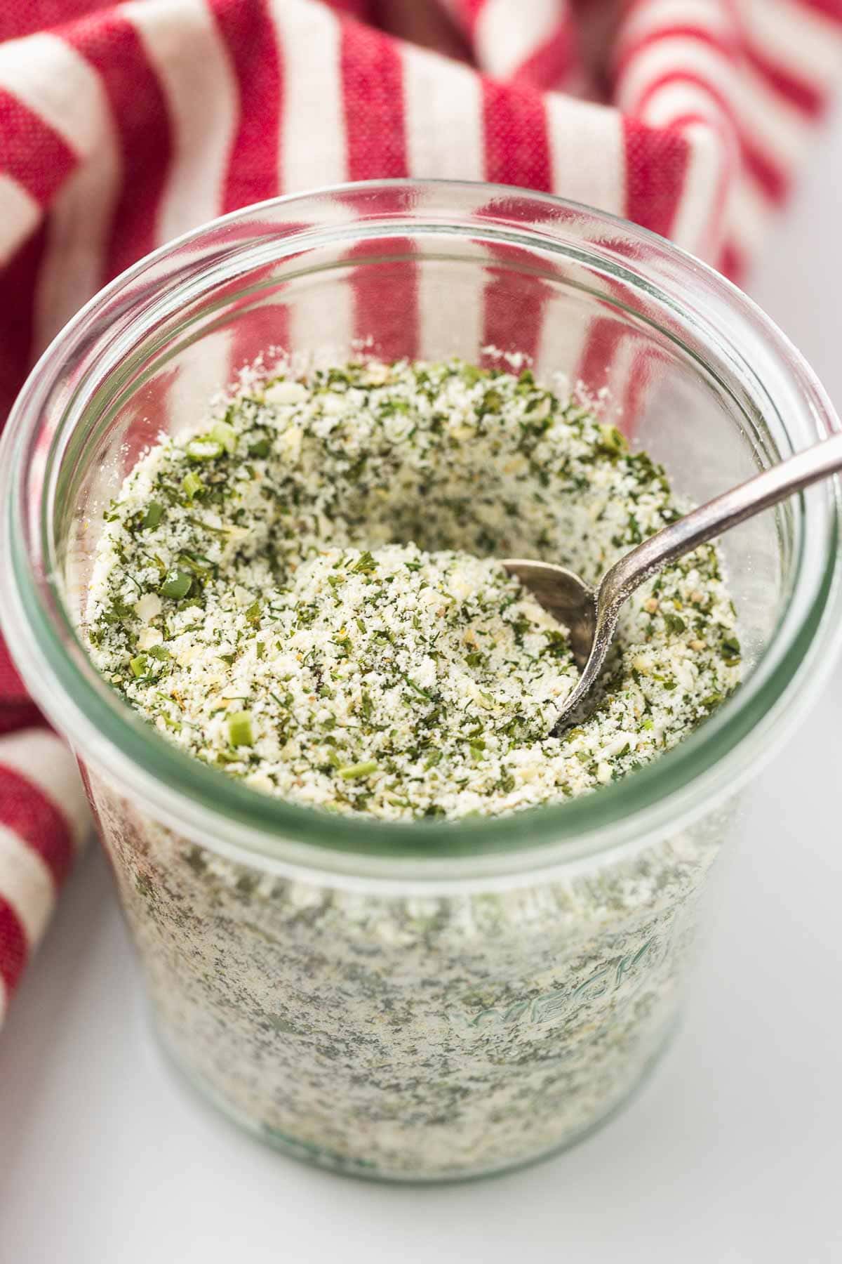 Homemade ranch seasoning in a Weck jar with a dessert spoon.