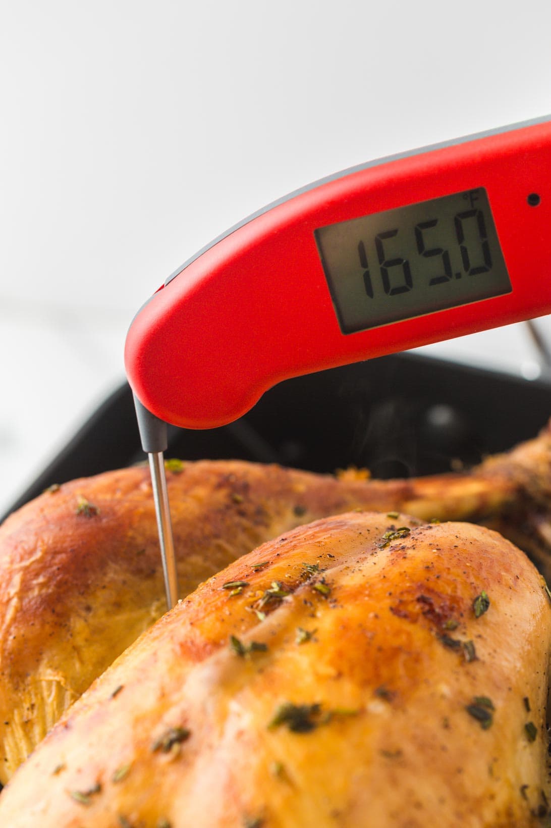 Checking the turkey temperature with Thermapen, registering 165°F