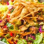 Asian chicken salad with wonton chips, in a large serving bowl