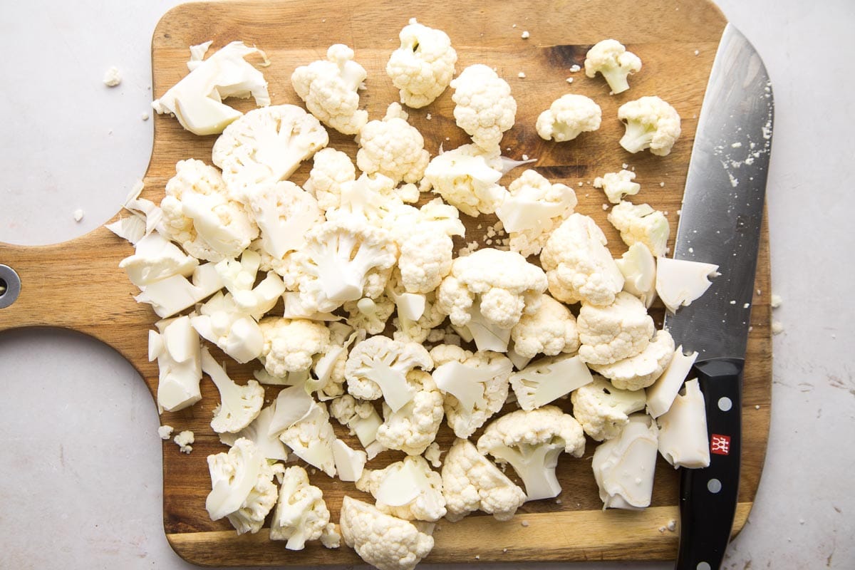 Chopping cauliflower on a wooden board with a Zwilling knife