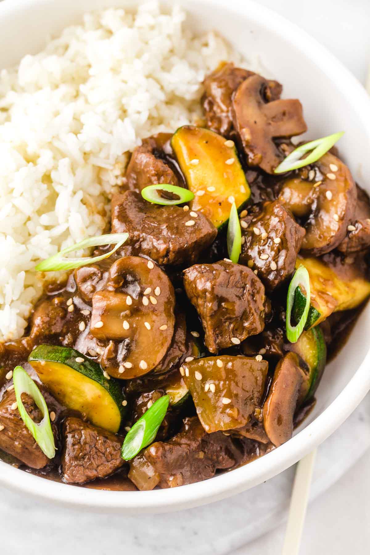 Hibachi steak over jasmine rice in a white bowl