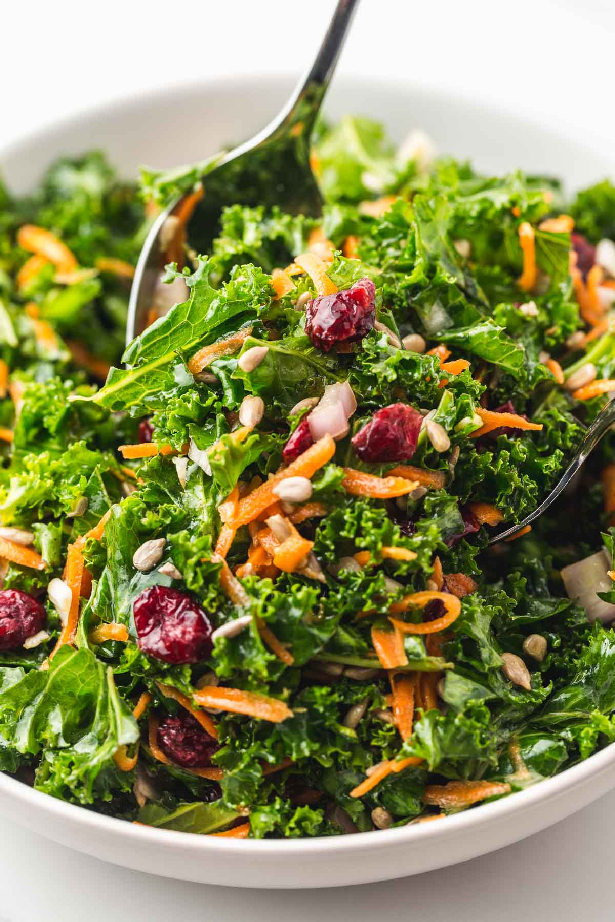 Tossing the salad with 2 serving spoons