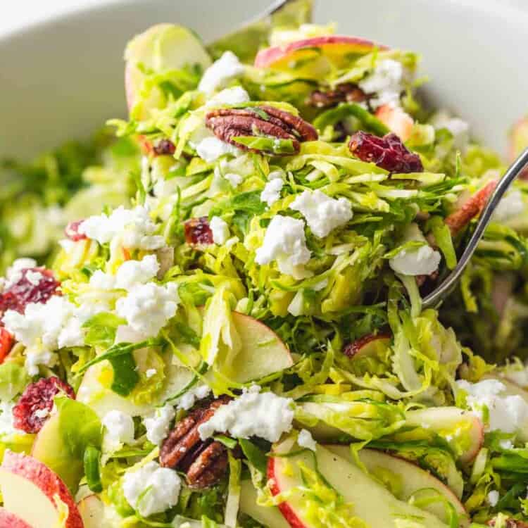 Tossing Shaved Brussels Sprout Salad using salad servers