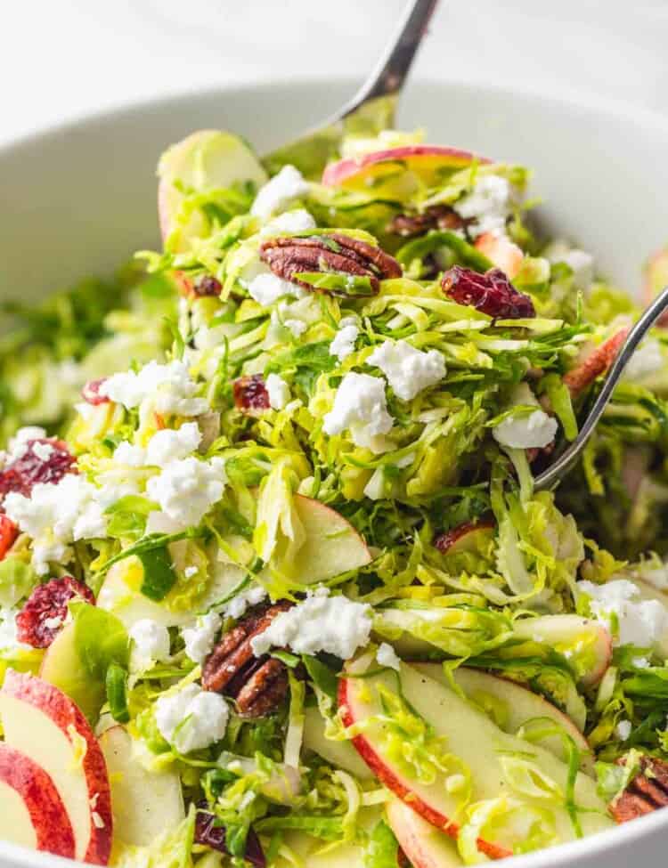 Tossing Shaved Brussels Sprout Salad using salad servers