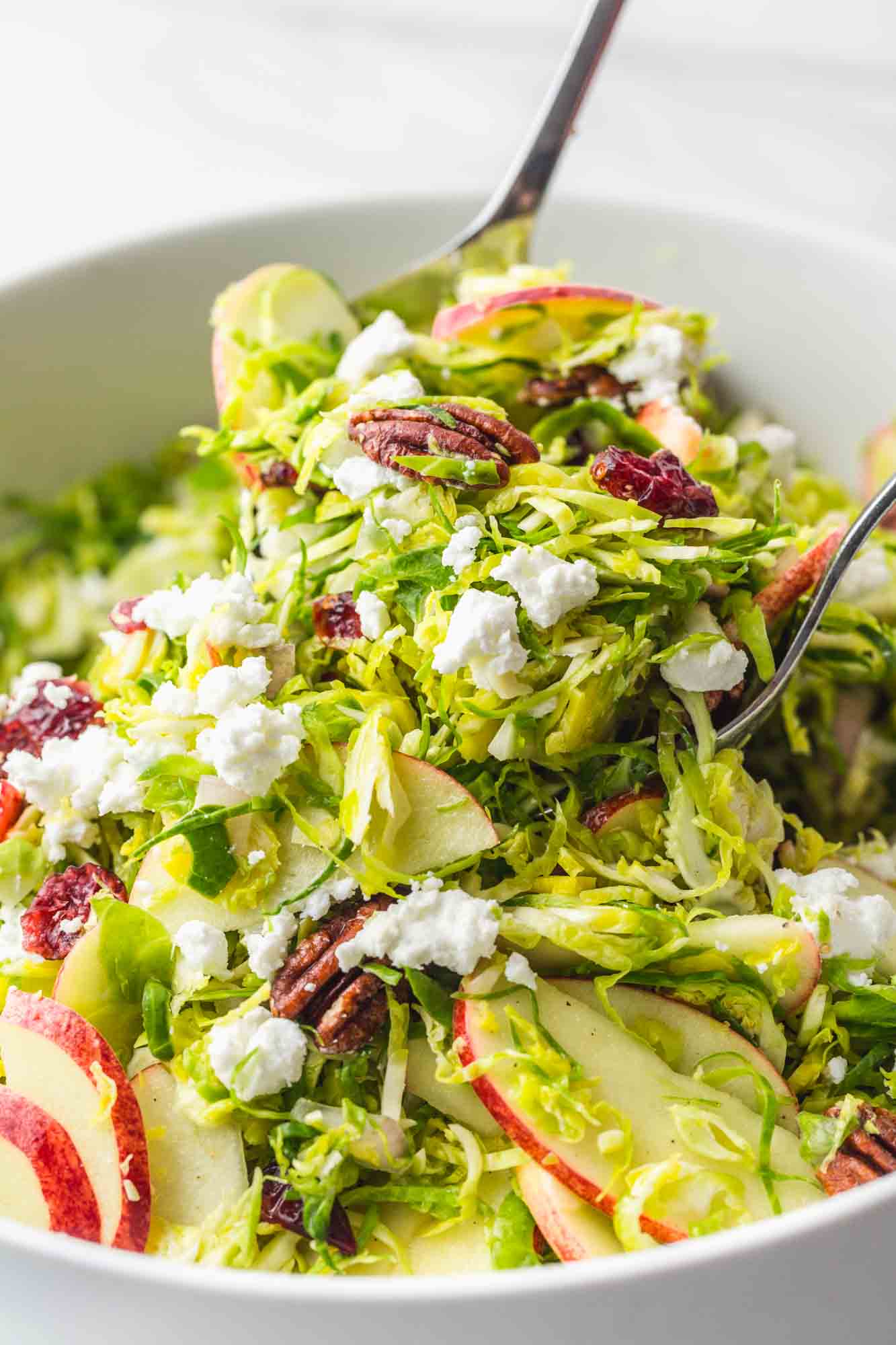 Tossing Shaved Brussels Sprout Salad using salad servers