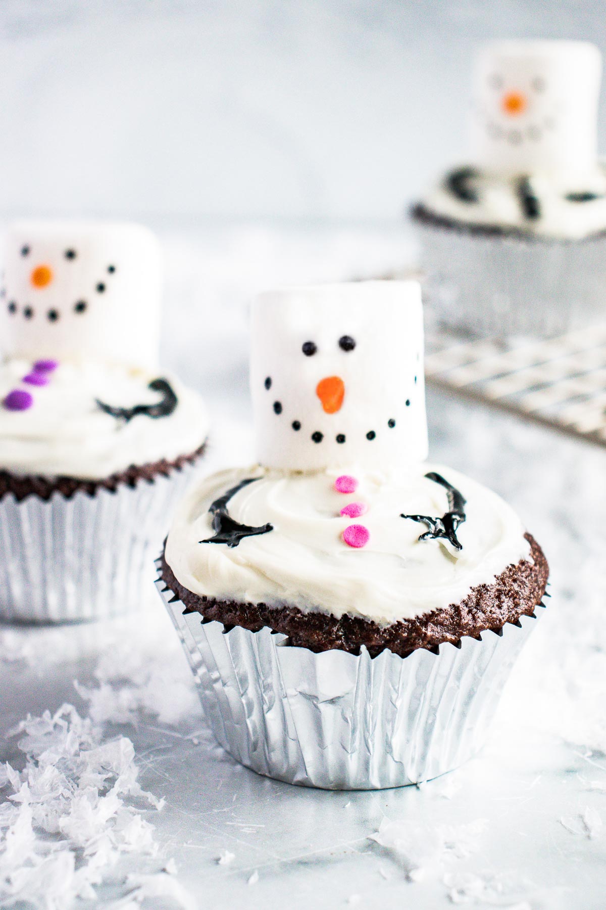 Snowman cupcakes on a marble countertop