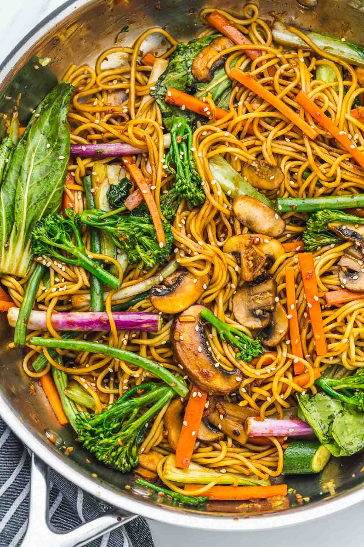 Overhead shot of vegetable stir fry in a large stainless steel pan.