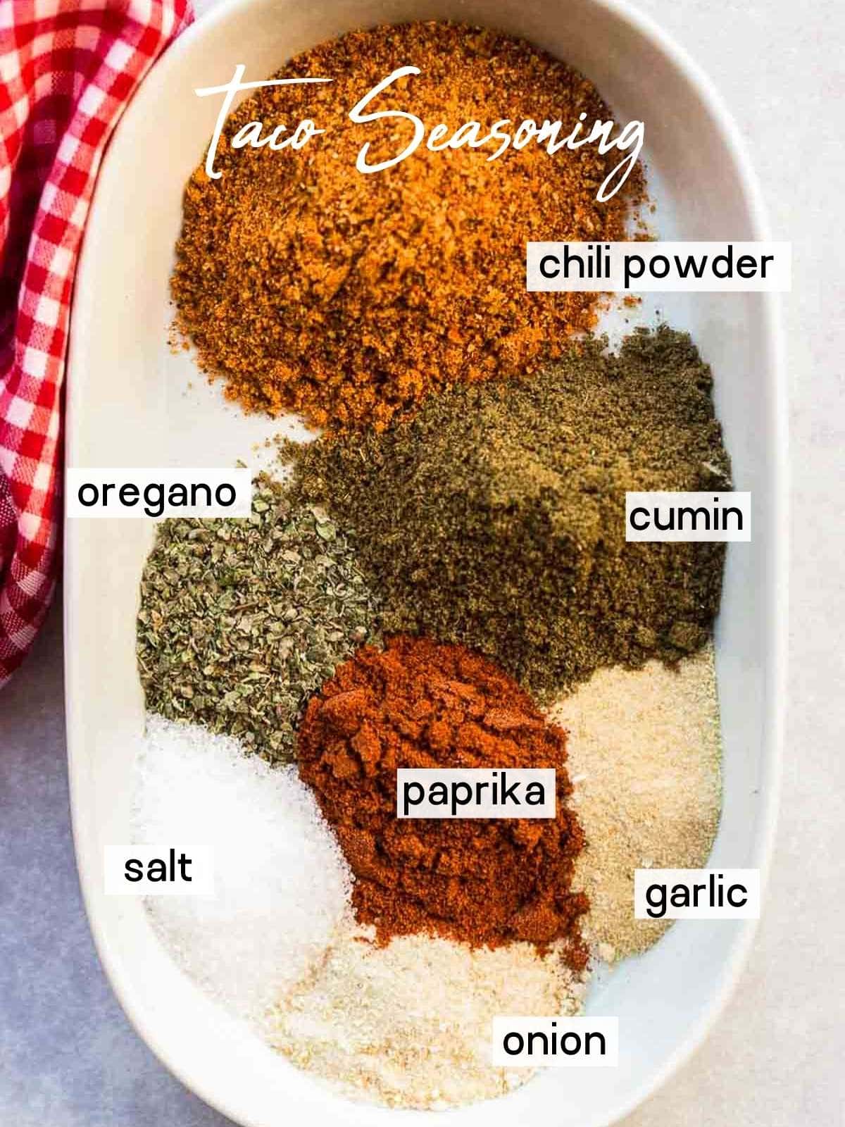 homemade taco seasoning ingredients measured out in small white bowl