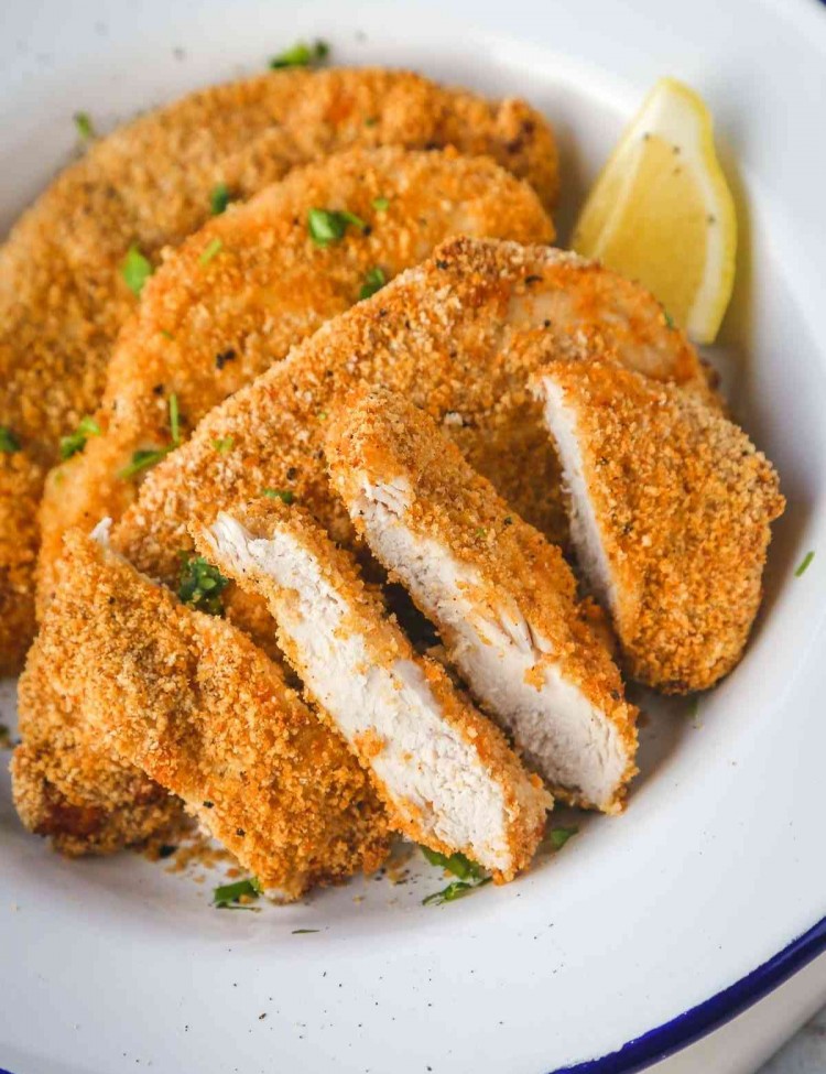 crispy air fryer chicken breasts, sliced and plated