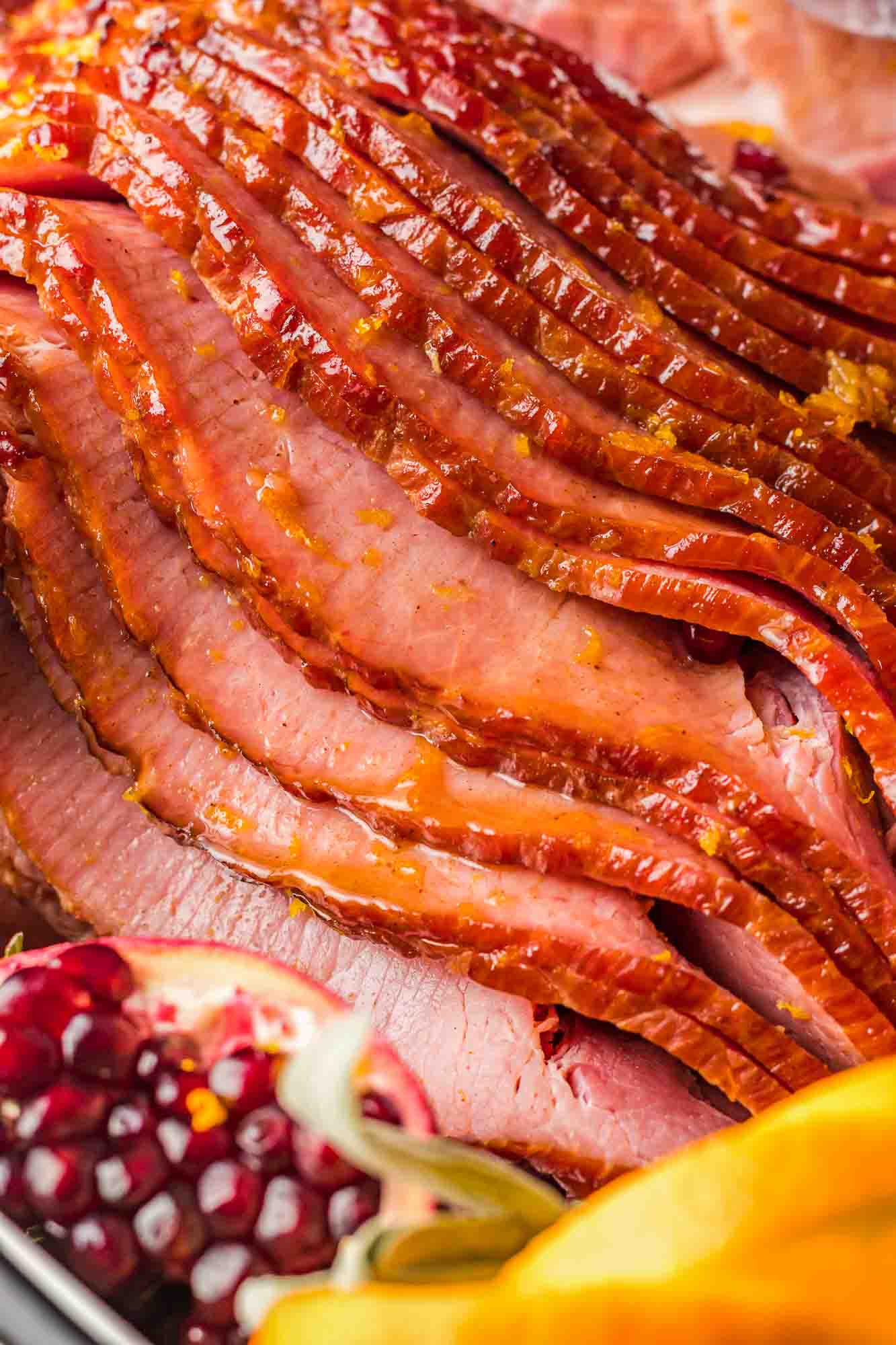 Spiral sliced ham close up, with orange honey glaze ready to be served.