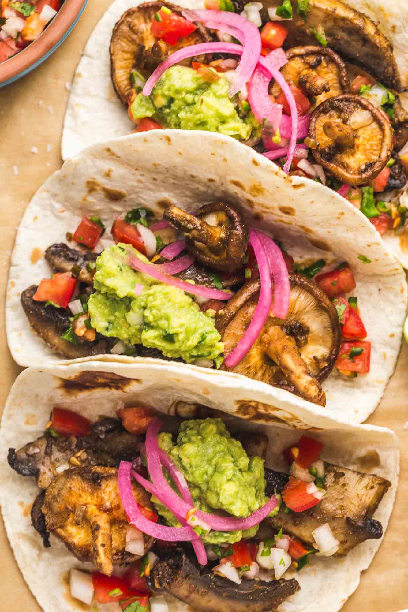 3 mushroom tacos with guacamole and quick pickled onions