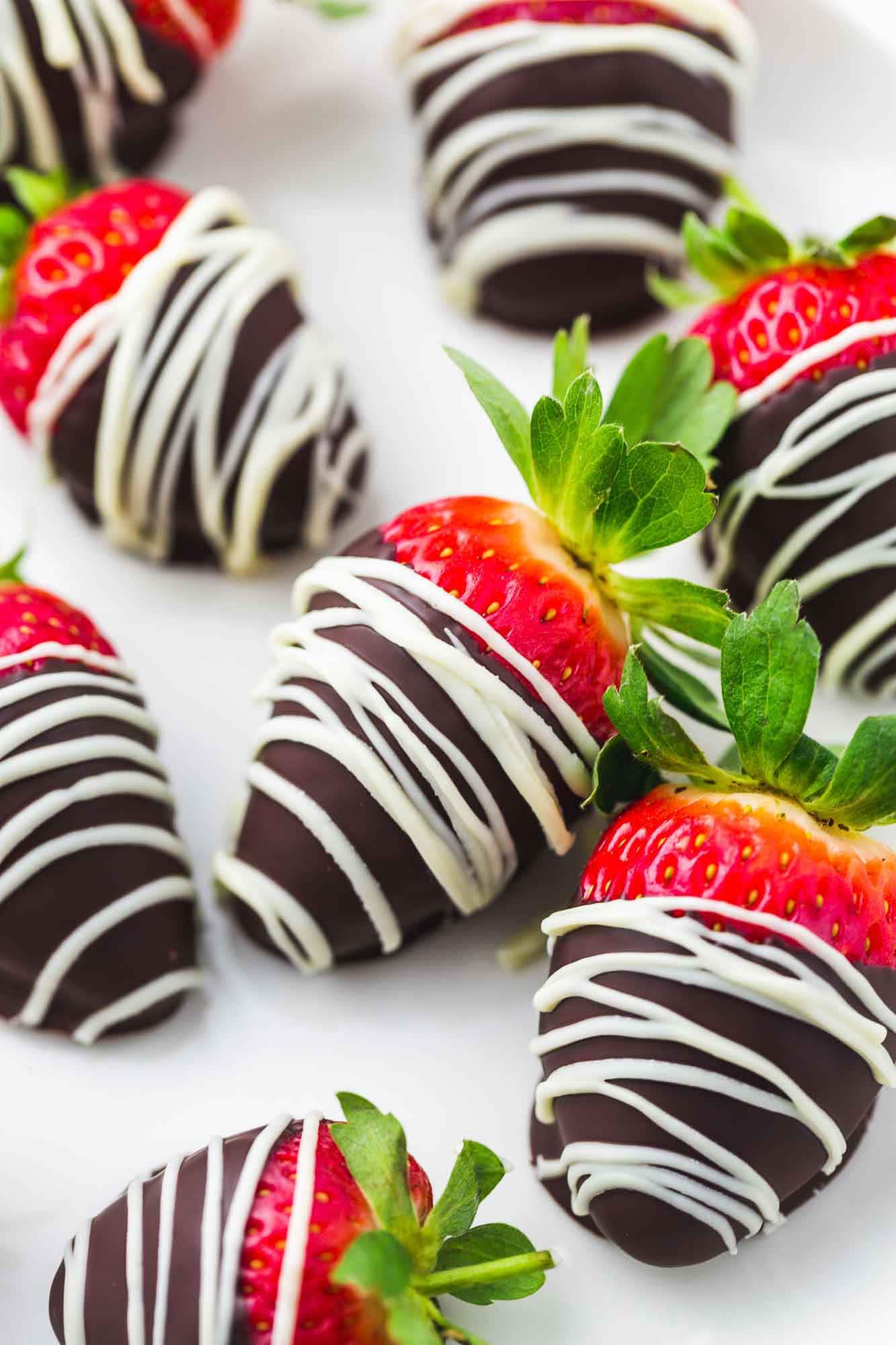 Close up image of chocolate covered strawberries with white chocolate drizzle