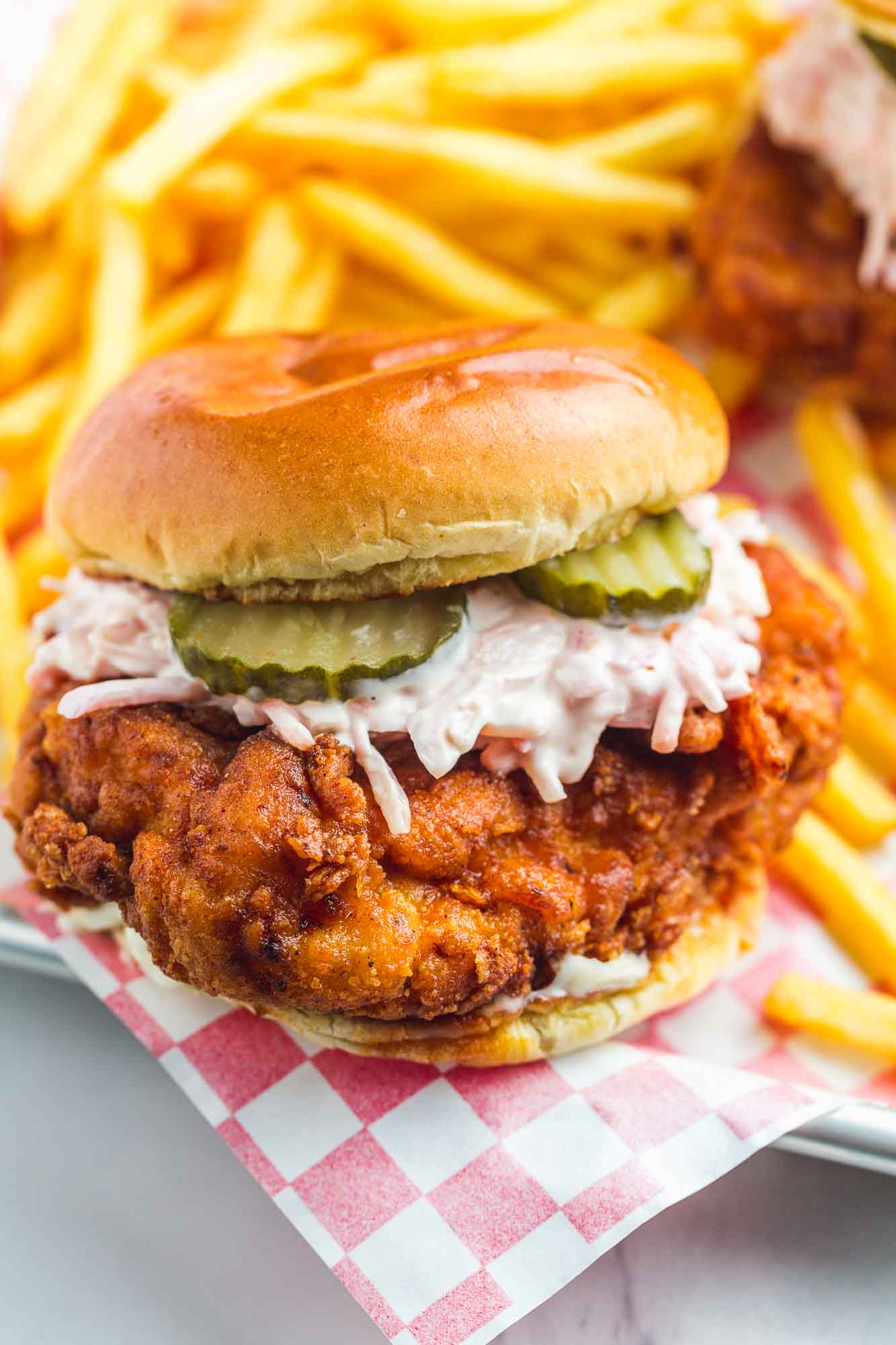 Nashvile-style hot chicken sandwich with coleslaw and pickle chips. 